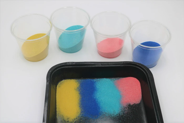 It's easy to create gorgeous colored sand art with adhesive or sticky boards.